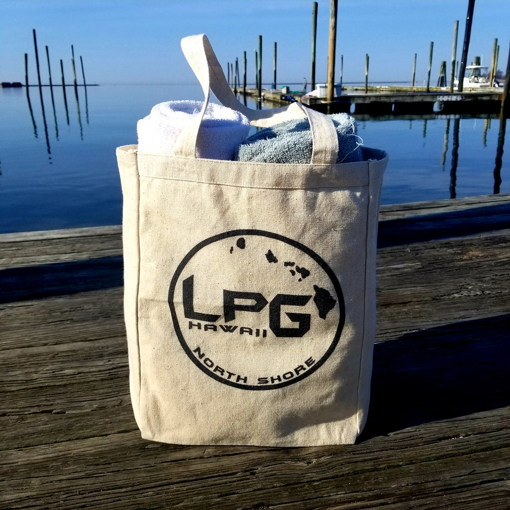 LPG Apparel Co. Hawaii North Shore Surf. Fish. Dive.  10oz. Natural Canvas Cotton Tote, Beach Tote Bag, School Tote Bag, Hawaii Tote Bag, Hawaii Vacation Tote, Hawaii Gift, Hawaii Beach Bag, Hawaii Surf Bag on a dock overlooking the ocean
